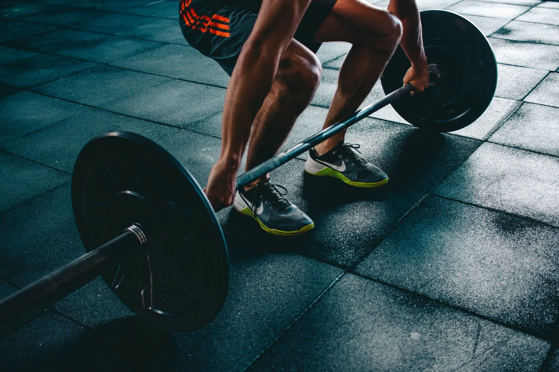 An athlete lifting a barbell in a strength training gym